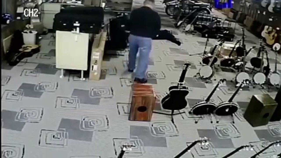 Robber plays dead as store owner points a gun at his head
