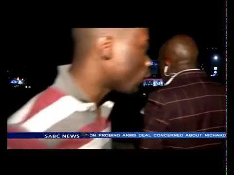 South African news reporter gets mugged live on air.